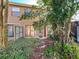 View of backyard with sliding glass door and landscaping at 606 Casa Park I Court, Winter Springs, FL 32708