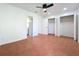 Spacious bedroom with terracotta tile flooring, a ceiling fan, closets, and ensuite bathroom at 606 Casa Park I Court, Winter Springs, FL 32708