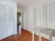 Upstairs hallway with terracotta tile flooring, multiple closet doors, and easy access to the bedrooms at 606 Casa Park I Court, Winter Springs, FL 32708