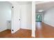 Hallway featuring terracotta tile flooring, leading to a sunlit living area, with access to a half-bathroom at 606 Casa Park I Court, Winter Springs, FL 32708