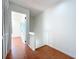 Upstairs hallway with a half-wall divider, terracotta tile flooring, and a bedroom entry at 606 Casa Park I Court, Winter Springs, FL 32708