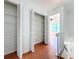 Hallway with large storage closets featuring wire shelving and terracotta tile flooring at 606 Casa Park I Court, Winter Springs, FL 32708