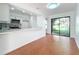 Open-concept kitchen with breakfast bar and sliding glass doors to the yard at 606 Casa Park I Court, Winter Springs, FL 32708