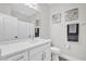 Bright bathroom featuring a white vanity, framed mirror and neutral wall art at 6132 Saint Julian Dr, Sanford, FL 32771