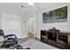 A view of the bedroom, featuring luxury vinyl flooring, a comfortable chair, and an entertainment center at 6132 Saint Julian Dr, Sanford, FL 32771