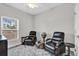 A bedroom featuring luxury vinyl floors, two chairs, and a large window providing plenty of natural light at 6132 Saint Julian Dr, Sanford, FL 32771