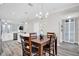 A view of the dining room, adjacent to the kitchen, and featuring luxury vinyl floors and modern lighting at 6132 Saint Julian Dr, Sanford, FL 32771