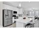 A view of the kitchen, which includes a kitchen island, stainless steel appliances, and white cabinets at 6132 Saint Julian Dr, Sanford, FL 32771