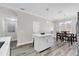 A view of the kitchen, which includes a kitchen island, luxury vinyl floors, and stainless steel appliances at 6132 Saint Julian Dr, Sanford, FL 32771