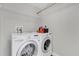 Laundry room with front loading washer and dryer under a wire shelf at 6132 Saint Julian Dr, Sanford, FL 32771