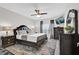 Spacious primary bedroom featuring a king bed, ceiling fan, and dark wood furniture at 6132 Saint Julian Dr, Sanford, FL 32771