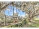 Charming backyard featuring a playground, seating and garden area beneath mature, moss-draped trees at 632 Tranquil Oaks Ln, Oviedo, FL 32765