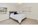 Bright bedroom featuring a bed with white linens, neutral walls, and natural light through windows at 632 Tranquil Oaks Ln, Oviedo, FL 32765