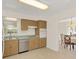 Cozy kitchen featuring light wood cabinets and an open doorway at 632 Tranquil Oaks Ln, Oviedo, FL 32765