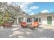 Patio with seating area, pergola, lush plants, and serene backyard at 632 Tranquil Oaks Ln, Oviedo, FL 32765