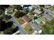 Aerial view of a residential neighborhood with tree-lined streets and well-kept homes at 702 Apricot Dr, Ocoee, FL 34761