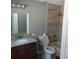 Bathroom featuring granite vanity, large mirror, modern fixtures, and tiled shower-tub combination for a functional space at 723 Jeffcoat St, Apopka, FL 32703