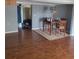 Inviting dining area with wood floors, a cozy dining set, and view into the living room with comfortable seating at 723 Jeffcoat St, Apopka, FL 32703