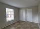 Neutral bedroom features tile flooring, closet, and a window for natural light at 7411 Golden Glenn Ct, Orlando, FL 32807