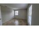 Cozy bedroom featuring tile flooring, neutral-colored walls, and natural light from a window at 7411 Golden Glenn Ct, Orlando, FL 32807