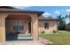 Beige single-story home featuring a covered carport and well-maintained landscaping on a sunny day at 7411 Golden Glenn Ct, Orlando, FL 32807