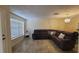 Bright living room with tile flooring, a large window, and a comfortable sectional sofa at 7411 Golden Glenn Ct, Orlando, FL 32807