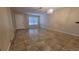 Spacious living room with neutral walls, tile flooring, and modern lighting at 7411 Golden Glenn Ct, Orlando, FL 32807