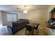 Living room featuring tile floors, a large window, and a chandelier for a cozy atmosphere at 7411 Golden Glenn Ct, Orlando, FL 32807