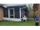 View of the home's screened-in lanai with green turf at 7411 Golden Glenn Ct, Orlando, FL 32807