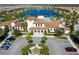 An aerial view of community clubhouse, pool and lake with a beautiful water fountain at 8948 Adriatico Ln, Kissimmee, FL 34747