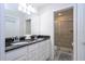 Bathroom featuring double sink vanity, granite countertops, and walk-in shower at 8948 Adriatico Ln, Kissimmee, FL 34747