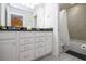 Stylish bathroom featuring a double vanity, granite countertop, and a shower-tub combination at 8948 Adriatico Ln, Kissimmee, FL 34747