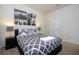 Relaxing bedroom featuring a queen-size bed, side tables, and a captivating wall art arrangement at 8948 Adriatico Ln, Kissimmee, FL 34747