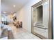 Bright foyer with white trim, tile floors, two accent chairs, and a large mirror at 8948 Adriatico Ln, Kissimmee, FL 34747