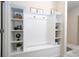 Charming mud room with bench, coat hooks, shelving, and decor at 8948 Adriatico Ln, Kissimmee, FL 34747