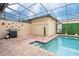 Pool with beautiful patio, lush plants, fun decor and outdoor cooking area at 8948 Adriatico Ln, Kissimmee, FL 34747