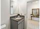 Clean bathroom featuring a granite vanity with a contemporary mirror and tiled flooring at 9537 Black Walnut Dr, Clermont, FL 34715