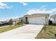 Inviting single-story home featuring a long driveway, well-maintained lawn, and a convenient two-car garage at 9537 Black Walnut Dr, Clermont, FL 34715