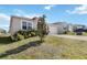 Inviting single-story home featuring a well-maintained lawn and a convenient two-car garage at 9537 Black Walnut Dr, Clermont, FL 34715