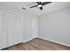 Neutral bedroom featuring modern fan, sleek flooring and closet space at 9913 Peddlers Way, Orlando, FL 32817