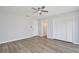 Bright bedroom featuring sleek flooring, ceiling fan, and ample closet space at 9913 Peddlers Way, Orlando, FL 32817