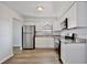 Bright kitchen with stainless steel appliances, granite countertops, and modern white cabinetry at 9913 Peddlers Way, Orlando, FL 32817