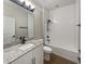 Bright bathroom featuring granite counters, white cabinets and modern black hardware and fixtures at 1038 Commuter Dr, Deltona, FL 32738