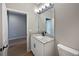 Granite countertop with white cabinets and modern black hardware and fixtures in the updated bathroom at 1038 Commuter Dr, Deltona, FL 32738