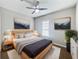 Beautiful bedroom featuring a ceiling fan, a light wood bed frame, and tasteful art at 1038 Commuter Dr, Deltona, FL 32738