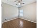 Clean bedroom with wood-look tile floors, neutral walls, and a window with white blinds at 1038 Commuter Dr, Deltona, FL 32738