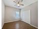 Bedroom with wood-look tile flooring, ceiling fan, neutral paint and a closet with bifold doors at 1038 Commuter Dr, Deltona, FL 32738