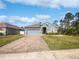 Charming single Gathering home with a well manicured lawn, brick driveway and craftsman style elevation at 1038 Commuter Dr, Deltona, FL 32738