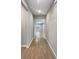 Hallway featuring wood-look tile floors and neutral walls leading to a bright living space at 1038 Commuter Dr, Deltona, FL 32738