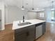 Kitchen island features a stainless steel dishwasher, modern sink and faucet in an open floor plan at 1038 Commuter Dr, Deltona, FL 32738